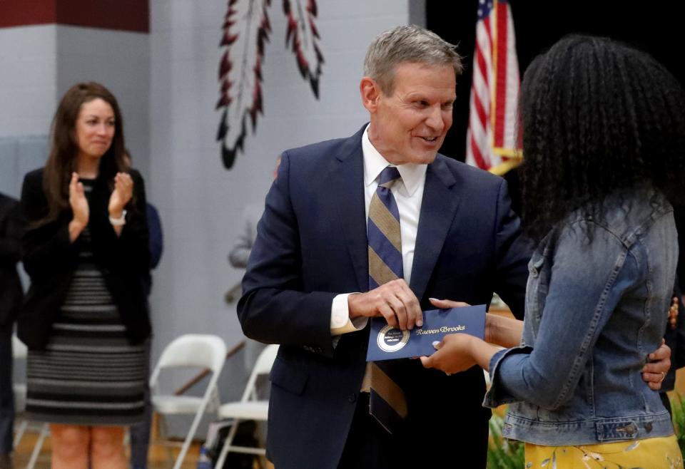 Tennessee Gov. Bill Lee appears alongside Tennesse Education Commissioner Penny Schwinn at an awards event at Black Fox Elementary in Cleveland, Tenn. on April 7, 2022. Here Lee presents a $25,000 check to second-grade teacher Raeven Brooks during a surprise school assembly. Brooks was awarded one of only two Milken Educator Awards, a high-stakes national recognition program for teachers, for her work during the 2021-22 school year.