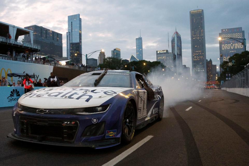 Shane van Gisbergen celebrates with a burnout after winning the NASCAR Cup Series Grant Park 220 on Sunday at the Chicago street course. The New Zealander won the first-time event in his NASCAR debut.