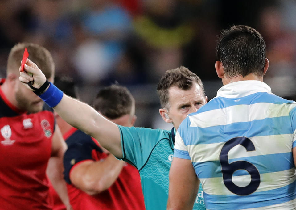 Referee Nigel Owens shows Argentina's Tomas Lavanini a red card after a dangerous tackle during the Rugby World Cup Pool C game at Tokyo Stadium between England and Argentina in Tokyo, Japan, Saturday, Oct. 5, 2019. (AP Photo/Christophe Ena)