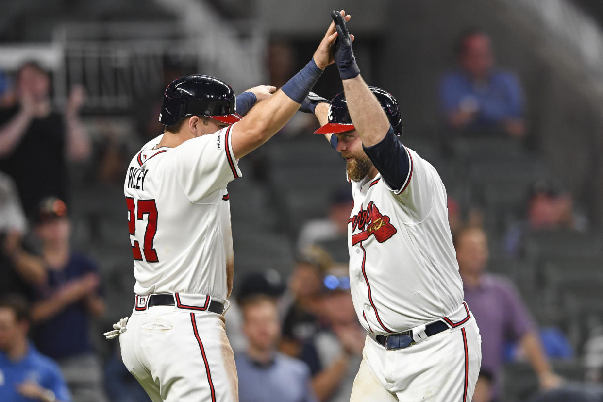 Jun 17, 2019; Atlanta, GA, USA; Atlanta Braves catcher Brian McCann (right) and Austin Riley (27) celebrate after both scored on a home run by McCann against the New York Mets during the eighth ninth inning at SunTrust Park. Mandatory Credit: Dale Zanine-USA TODAY Sports