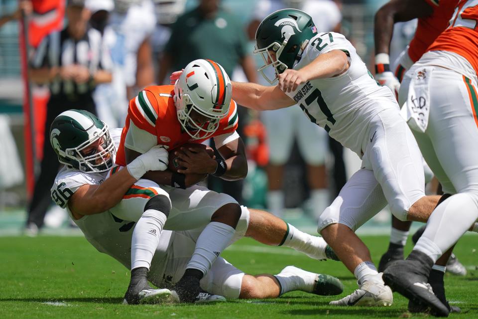 Sep 18, 2021; Miami Gardens, Florida, USA; Michigan State Spartans defensive end Jacub Panasiuk (96) sacks Miami Hurricanes quarterback D'Eriq King (1) during the first half at Hard Rock Stadium.