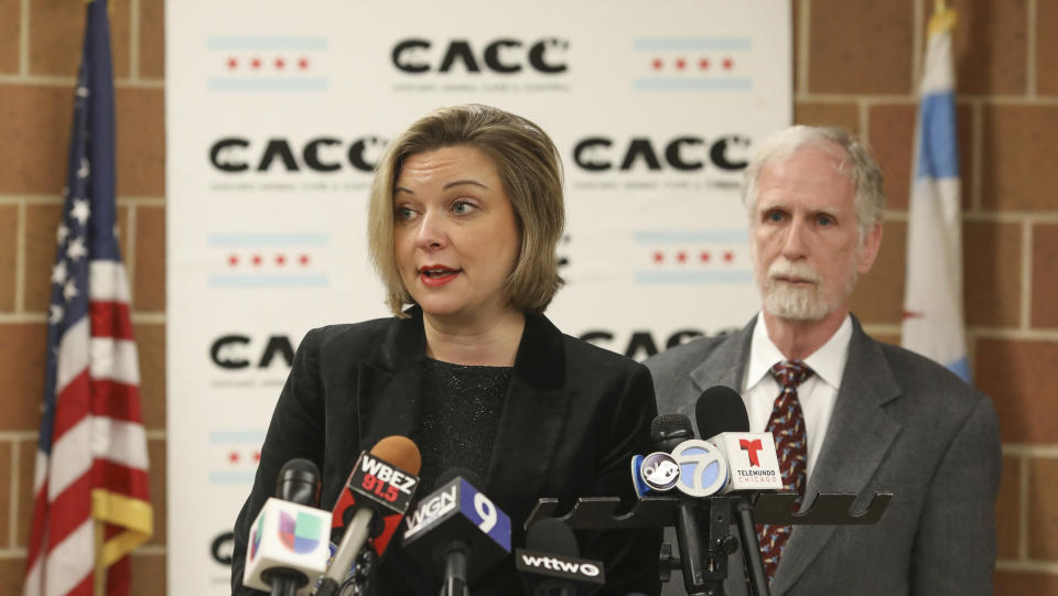 Kelley Gandurski, executive director of Chicago Animal Care and Control, speaks with reporters in Chicago, Thursday, Jan. 9, 2020, while Dr. Tom Wake, the interim administrator of Cook County Animal and Rabies Control, stands behind her. Authorities were on the hunt for coyotes in downtown Chicago after two reported attacks, including one where passersby said they had to pull a wild canine off of a 6-year-old boy who was bitten in the head. (AP Photo/Teresa Crawford)