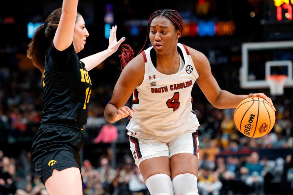 South Carolina Gamecocks forward Aliyah Boston (4) is guarded by Iowa Hawkeyes forward McKenna Warnock (14) in the NCAA Tournament Final Four game at the American Airline Center on Friday, March 31, 2023.