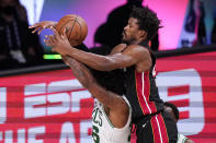 Miami Heat's Jimmy Butler, right, goes over the top of Boston Celtics' Marcus Smart (36) during the second half of an NBA conference final playoff basketball game Sunday, Sept. 27, 2020, in Lake Buena Vista, Fla. (AP Photo/Mark J. Terrill)