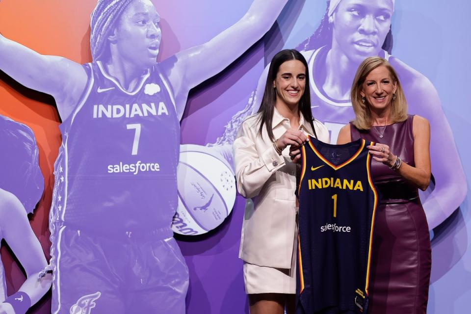 Iowa's Caitlyn Clark, left, poses for a photo with WNBA commissioner Cathy Engelbert after being selected first overall by the Indiana Fever during the first round of the WNBA basketball draft (AP)