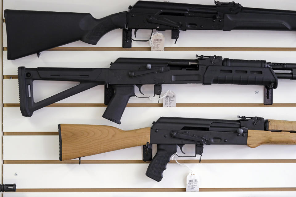 FILE - In this Oct. 2, 2018, file photo, semi-automatic rifles are displayed on a wall at a gun shop in Lynnwood, Wash. Lawmakers in Oregon are considering a proposed gun storage law that would be the among strongest in America (AP Photo/Elaine Thompson, File)