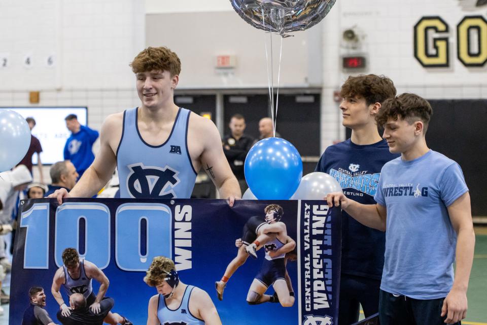 Brenan Morgan (left) celebrates his 100th career win after his semifinal match in the WPIAL Class 2A Northern Section Tournament at Keystone Oaks High School Saturday.