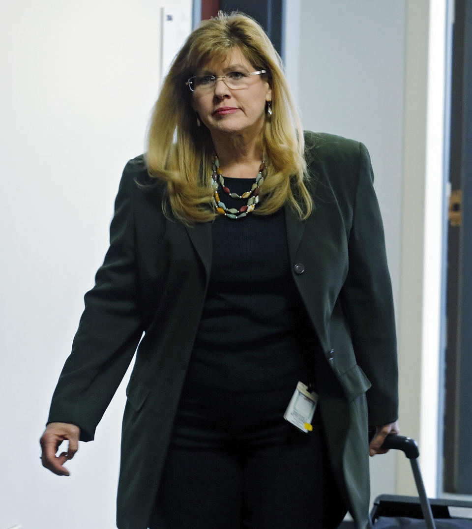 Asst. District Attorney Karen Pearson arrives for a hearing for Aurora theater shooting suspect James Holmes at district court in Centennial, Colo., on Friday Jan. 31, 2014. Holmes has pleaded not guilty by reason of insanity to charges of killing 12 people and injuring 70 at a Denver-area movie theater in July 2012. Prosecutors are seeking the death penalty. (AP Photo/Ed Andrieski, Pool)