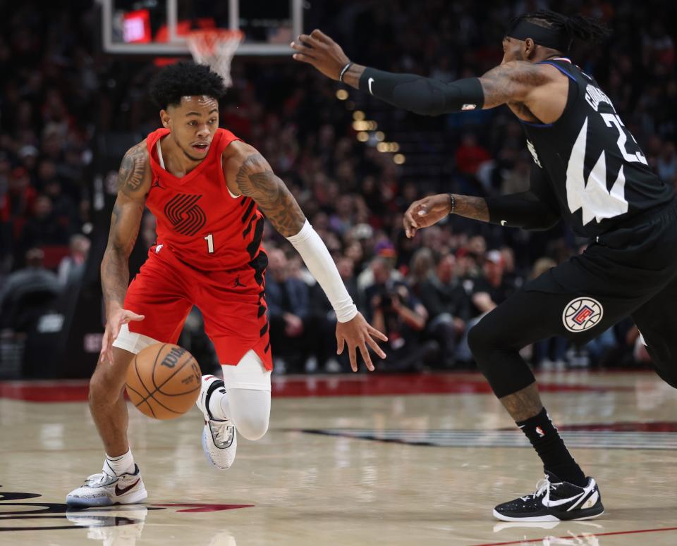 Portland Trail Blazers guard Anfernee Simons, left, drives against Los Angeles Clippers forward Robert Covington during the first half of an NBA basketball game in Portland, Ore., Tuesday, Nov. 29, 2022. (AP Photo/Steve Dipaola)