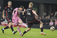 Inter Miami forward Lionel Messi, center attempts a shot on the goal past D.C. United midfielder Matti Peltola (4) during the second half of an MLS soccer match, Saturday, May 18, 2024, in Fort Lauderdale, Fla. (AP Photo/Lynne Sladky)