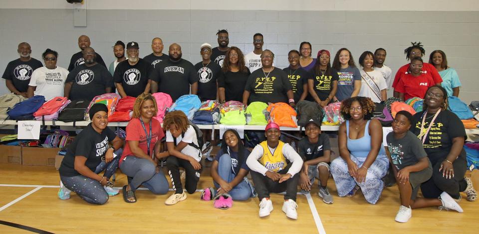 A group photo prior to the start of the Backpack to School Backpack Giveaway event held Saturday, Aug. 12, 2023, at the Erwin Center in Gastonia.