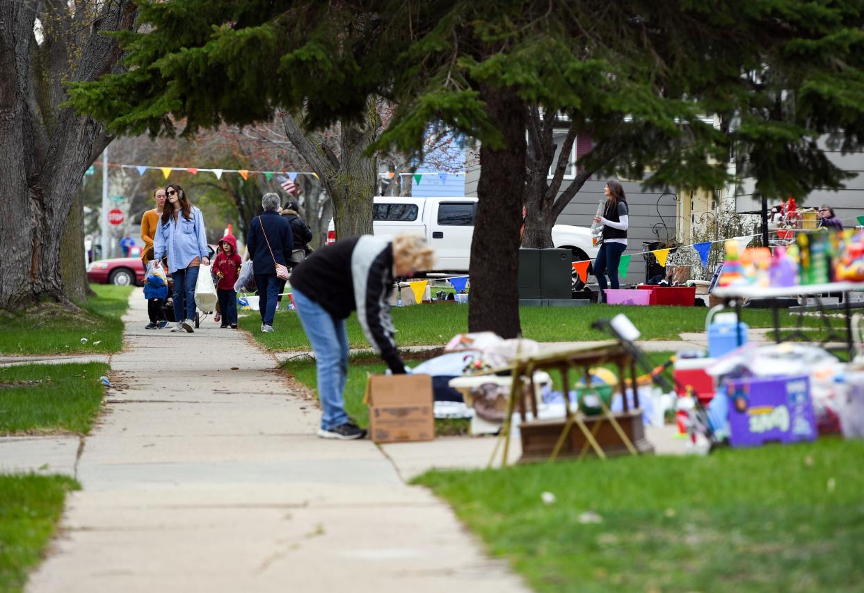 People walk from house to house during the first day of the Kingswood Rummage Sale on Wednesday, April 28, 2021, in Sioux Falls.