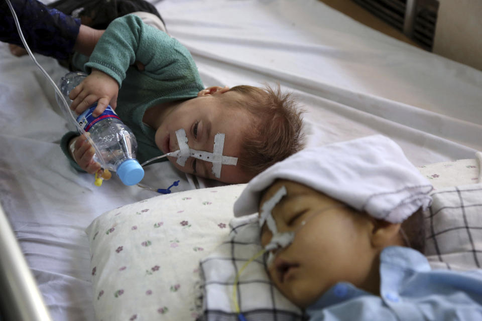 In this Oct. 15, 2019 photo, Afghan children receive treatment for respiratory problems at a pediatric hospital, in Kabul, Afghanistan. Afghanistan’s authorities are trying to tackle pollution in the country’s capital, which may be even deadlier than 18-year-old war. The research group State of Global Air said more than 26,000 deaths could be attributed to air pollution in 2017, compared to 3,483 civilians killed that year in the Afghan war. (AP Photo/Rahmat Gul)