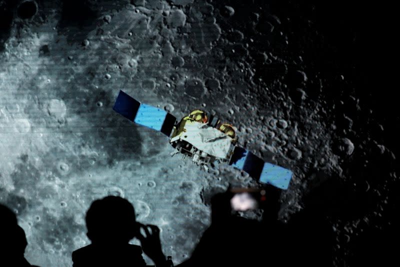 Screen shows footages of spacecraft for Chang'e-5 Mission, during an event on China’s lunar exploration program, at the National Astronomical Observatories of Chinese Academy of Sciences, in Beijing