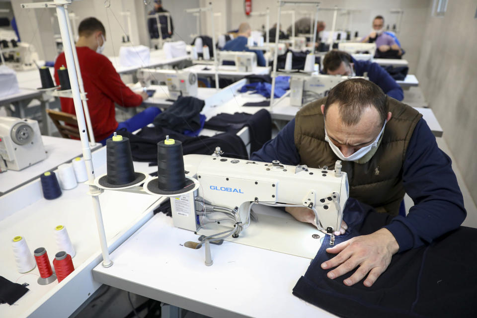 Inmates produce medical protection equipment in Zenica, Bosnia, on Nov. 23, 2021. In the early days of the pandemic and Bosnia was facing shortages of personal protective equipment, inmates in Zenica were offered to take up sewing protective face masks and other items as part of the prison's work program. (AP Photo)