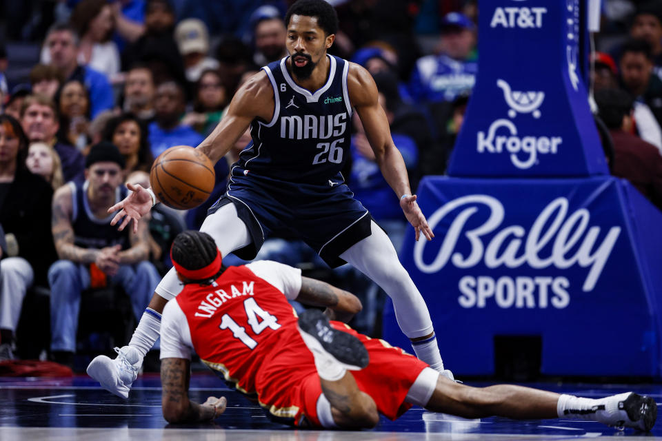 New Orleans Pelicans forward Brandon Ingram (14) and Dallas Mavericks guard Spencer Dinwiddie (26) reach for the ball during the second half of an NBA basketball game, Thursday, Feb. 2, 2023, in Dallas. (AP Photo/Brandon Wade)