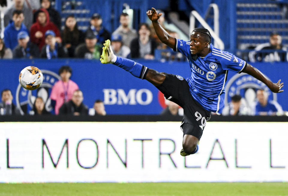 CF Montreal's Kwadwo Opoku jumps for the ball during the first half of the team's MLS soccer match against FC Cincinnati on Wednesday, Sept. 20, 2023, in Montreal. (Graham Hughes/The Canadian Press via AP)