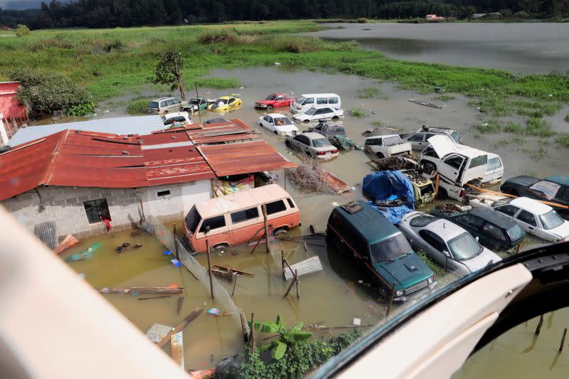Car damaged by floods are seen near an area hit by a mudslide, caused by heavy rains brought by Storm Eta, as the search for victims continue in the buried village of Queja