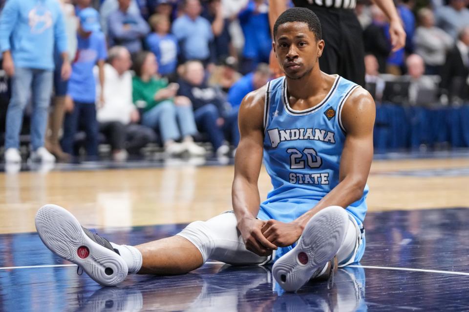 Indiana State Sycamores guard Jayson Kent (20) sits on the ground in disappointment Thursday, April 4, 2024, during the NIT championship game at Hinkle Fieldhouse in Indianapolis. The Seton Hall Pirates defeated the Indiana State Sycamores, 79-77.