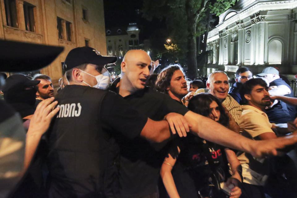 Nika Melia, head of the United National Movement, center, and other opposition protesters who gather to protest against "the Russian law" try to brake through a police line in Tbilisi, Georgia, on Tuesday, April 30, 2024. Clashes erupted between police and opposition demonstrators protesting a new bill intended to track foreign influence that the opposition denounced as Russia-inspired. (AP Photo/Zurab Tsertsvadze)