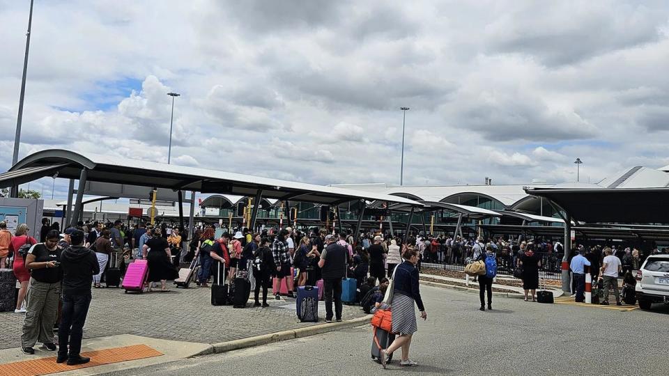 Hundreds of people were spotted outside the airport waiting further information. Photo: James Sinnet King