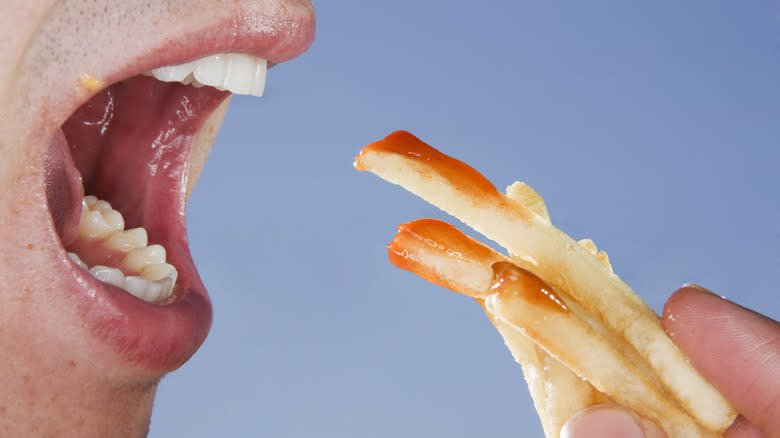 person eating fries