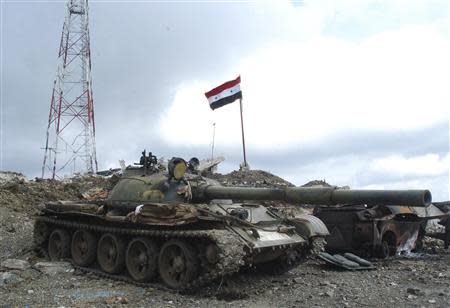 A tank belonging to forces loyal to Syrian President Bashar al-Assad is seen at one of the sites in Latakia mountains, after they took control of it from rebel fighters, April 3, 2014, in this handout released by Syria's national news agency SANA. REUTERS/SANA/Handout