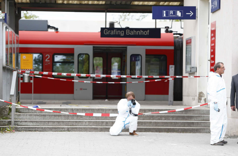 A police officer takes pictures at the train station after an attack in Grafing, southeast of Munich, Germany, May 10, 2016. (REUTERS/Michaela Rehle)     