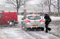 Someone walks through the snow along the Clyde in Glasgow, as snow and ice brought disruption to roads on Monday morning as the country faced its first major bout of wintry weather.