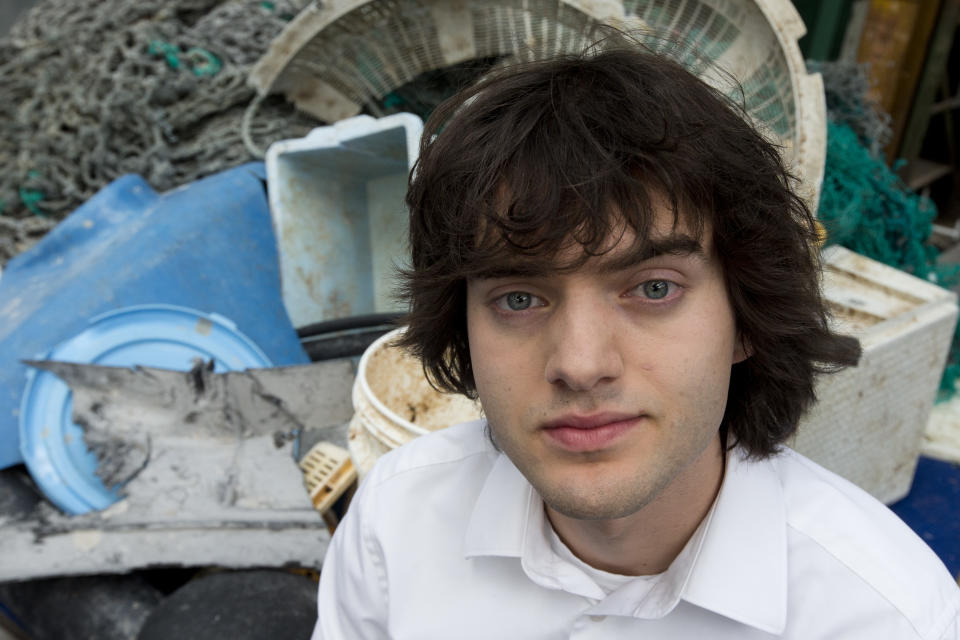 FILE - In this May 11, 2017, file photo, Dutch innovator Boyan Slat poses for a portrait next to a pile of plastic garbage prior to a press conference in Utrecht, Netherlands. Engineers will deploy a trash collection device to corral plastic litter floating between California and Hawaii in an attempt to clean up the world's largest garbage patch in the heart of the Pacific Ocean. The 2,000-foot (600-meter) long floating boom will be towed Saturday, Sept. 8, 2018, from San Francisco to the Great Pacific Garbage Patch, an island of trash twice the size of Texas. The system was created by The Ocean Cleanup, an organization founded by Slat. (AP Photo/Peter Dejong, File)