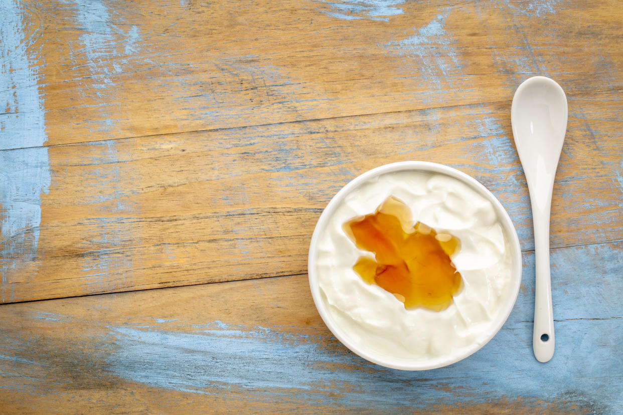 A bowl of yogurt with honey. 