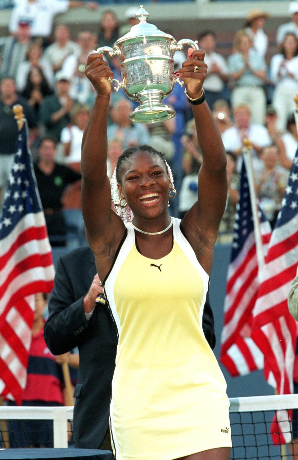 Serena Williams smiles and poses with her trophy after winning the US Open at the USTA National Tennis Courts in Flushing Meadows, New York.