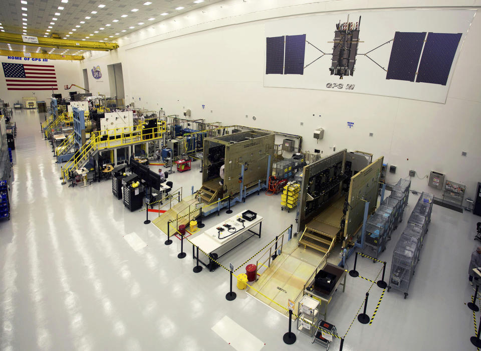 This Sept. 2, 2016 photo provided by Lockheed Martin shows GPS III satellites being built in a clean room at Lockheed Martin's complex south of Denver. The first GPS III satellite is scheduled to be launched from Cape Canaveral, Fla., on Tuesday, Dec. 18, 2018. (Pat Corkery/Lockheed Martin via AP)