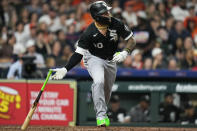 Chicago White Sox's Yoan Moncada watches his RBI double against the Houston Astros during the sixth inning of a baseball game Friday, March 31, 2023, in Houston. (AP Photo/Eric Christian Smith)