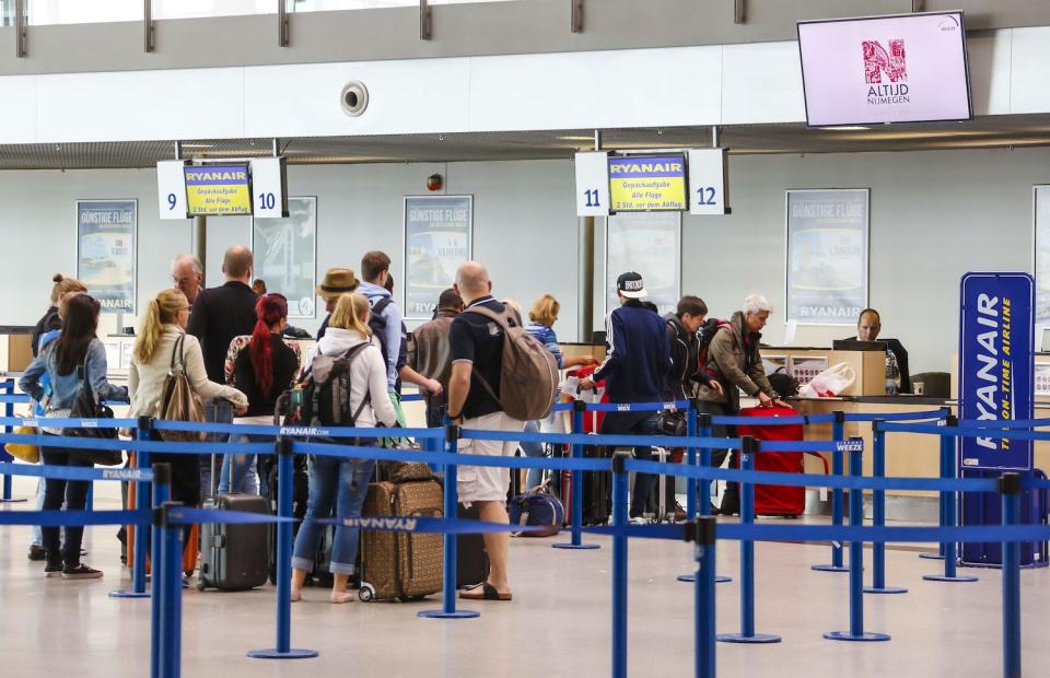 Οι επιβάτες κάνουν ουρά στο γραφείο check-in της Ryanair.