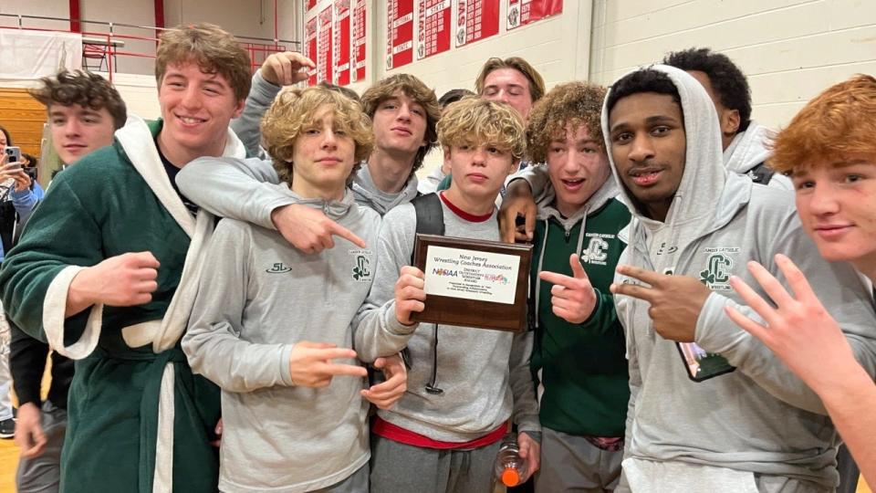 Wayne Rold (center) poses with his teammates and the District 27 Most Outstanding Wrestler's plaque after Camden Catholic's team championship was announced at Cherry Hill High School East on Saturday, February 19, 2022.