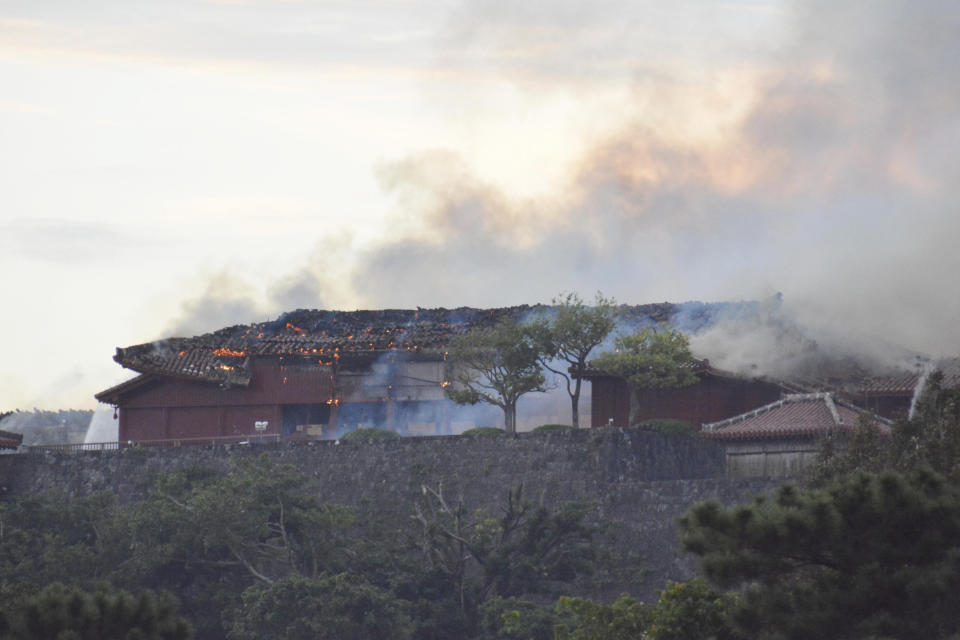 Smoke rises from the burning north hall of Shuri Castle in Naha, Okinawa, southern Japan, Thursday, Oct. 31, 2019. A fire spread among structures at Shuri Castle on Japan's southern island of Okinawa, nearly destroying the UNESCO World Heritage site. (Tomomi Tomita/Kyodo News via AP)