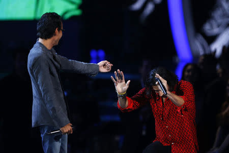 Nasri from the band Magic! bows to Marc Anthony after perforning "Cruel/Rude". REUTERS/Mike Blake