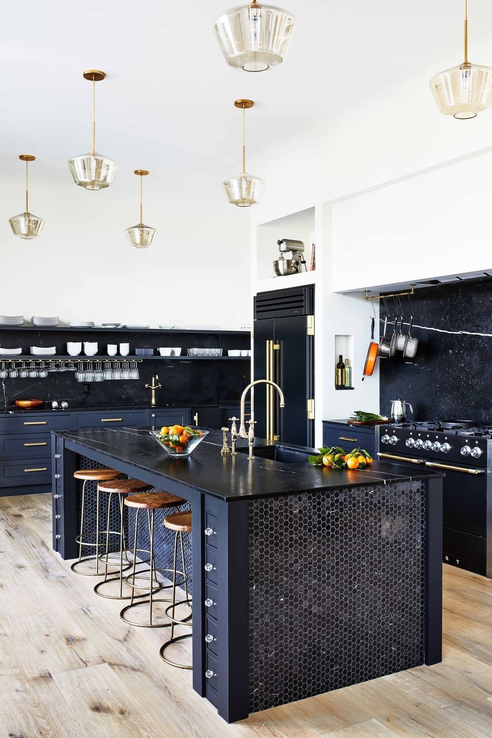 a kitchen with a bar and stools