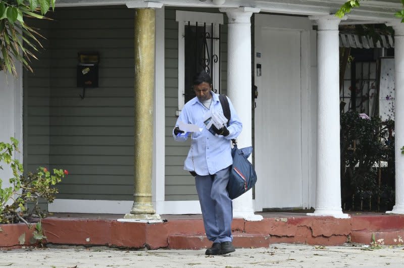 A mailman delivers mail in Los Angeles on Monday in the wet aftermath of what was left of Tropical Storm Hilary. Photo by Jim Ruymen/UPI