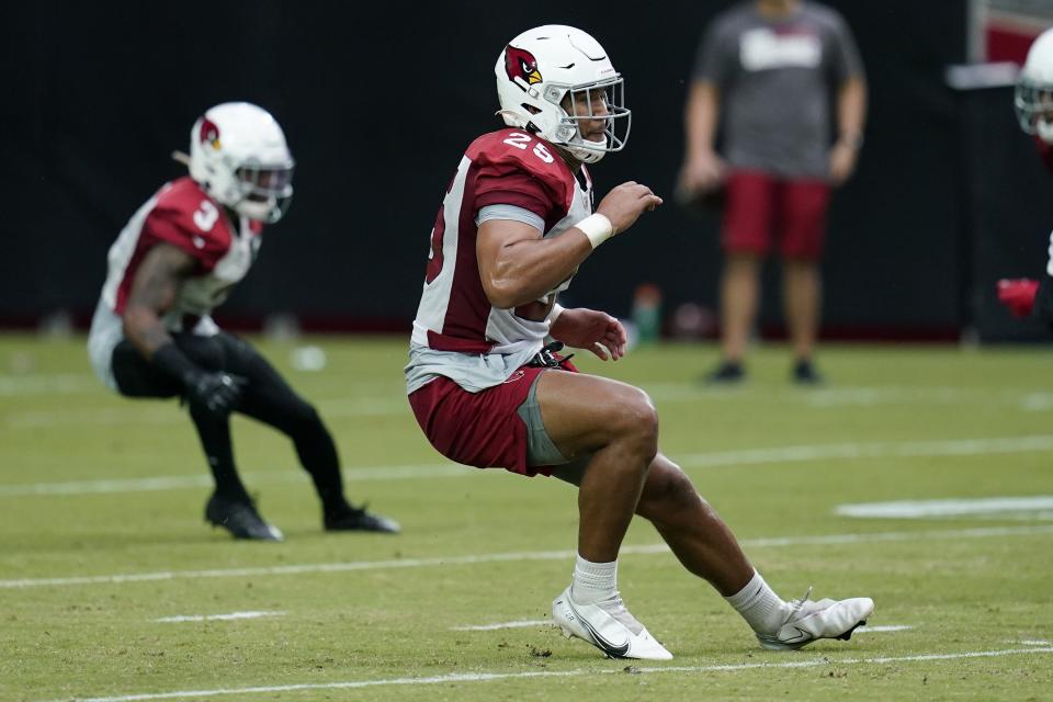 Arizona Cardinals linebacker Zaven Collins (25) and Cardinals strong safety Budda Baker (3) change directions to defend a running play during NFL football training camp practice, Saturday, July 31, 2021, in Glendale, Ariz. (AP Photo/Ross D. Franklin)