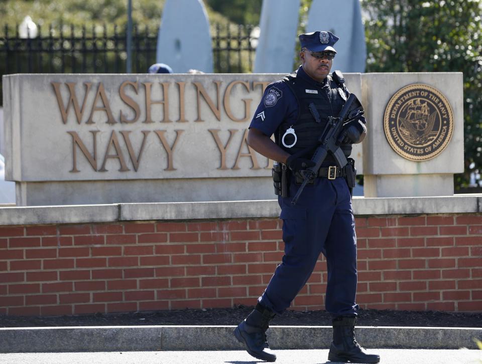 A police officer stands at the main gate of the Washington Navy Yard in Washington