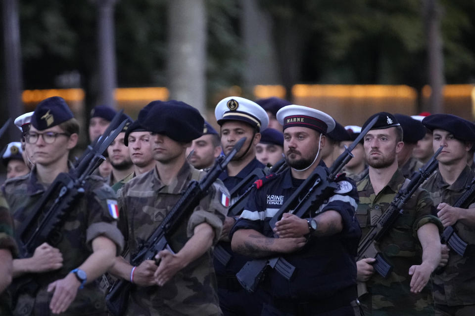 French soldiers march on the Champs Elysees avenue during a rehearsal for the Bastille Day parade in Paris, France, Monday, July 11, 2022. Paris is preparing for a big Bastille Day parade later this week, a military show on the Champs-Elysees avenue that this year will honor war-torn Ukraine and include troops from countries on NATO's eastern flank: Poland, Hungary, Slovakia, Romania, Bulgaria, Czechia, Lithuania, Estonia and Latvia. (AP Photo/Christophe Ena)