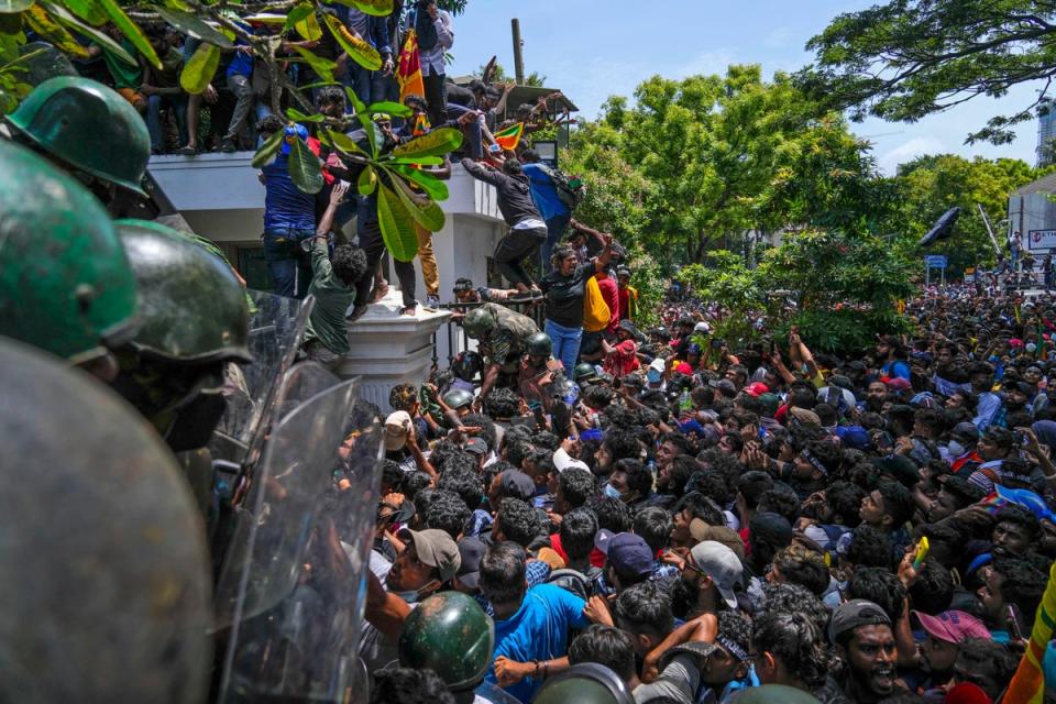 Protesters storm the office of the Sri Lankan prime minister Ranil Wickremesinghe (AP)