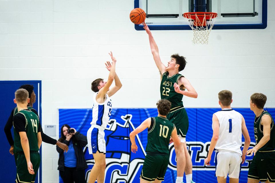 Iowa City West's Jack McCaffery (22) blocks the shot of Clear Creek Amana's Cale Berry during a high school boys basketball game