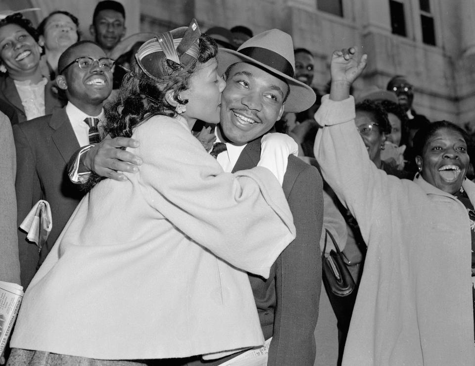 In this March 22, 1956, file photo, the Rev. Martin Luther King Jr. is welcomed with a kiss by his wife Coretta after leaving court in Montgomery, AL. King was found guilty of conspiracy to boycott city buses in a campaign to desegregate the bus system, but a judge suspended his $500 fine pending appeal.