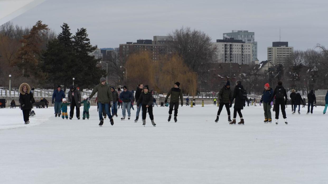 A row of skaters travel along the Rideau Canal Skateway on Feb. 20, 2024. On Tuesday afternoon the NCC opened an extra section of the skateway, one day after the end of Winterlude. (Jean Delisle/CBC - image credit)