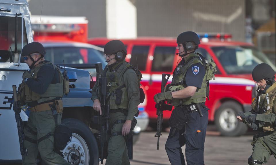 Armed law enforcement officers gather at Arapahoe High School, after a student opened fire in the school in Centennial, Colorado