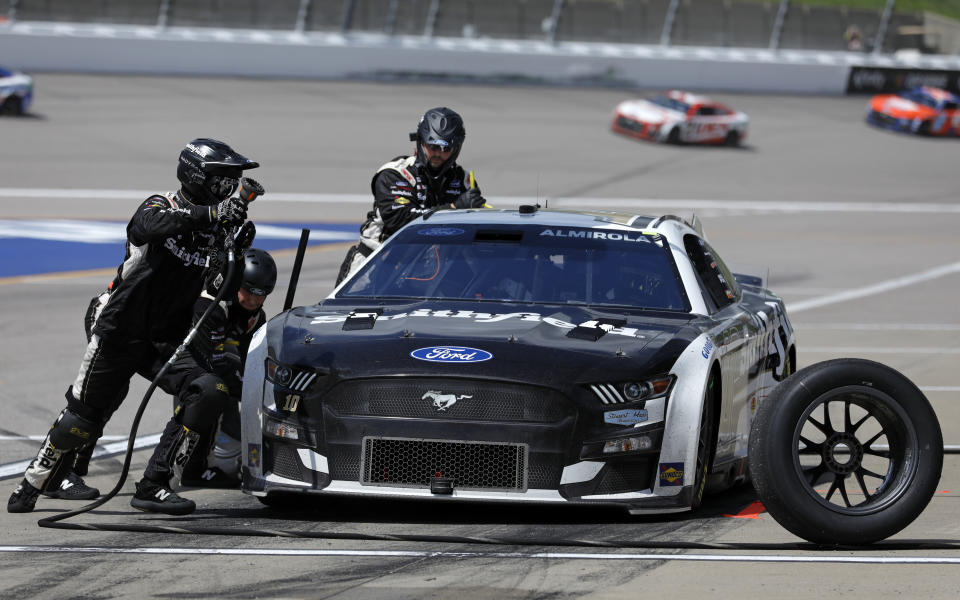 Aric Almirola (10) receives a tire change during a caution at a NASCAR Cup Series auto race at Kansas Speedway in Kansas City, Kan., Sunday, May 15, 2022. (AP Photo/Colin E. Braley)