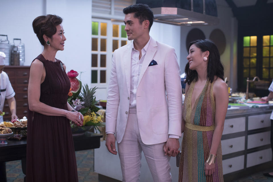 This image released by Warner Bros. Entertainment shows Michelle Yeoh, from left, Henry Golding and Constance Wu in a scene from the film "Crazy Rich Asians." When “Crazy Rich Asians” surpassed expectations and grabbed the top spot in its opening weekend, the film also pulled off another surprising feat. It put Asians of a certain age in theater seats. Younger Asian-Americans have been flocking with their parents to see the first movie in 25 years with an all-Asian cast. (Sanja Bucko/Warner Bros. Entertainment via AP)